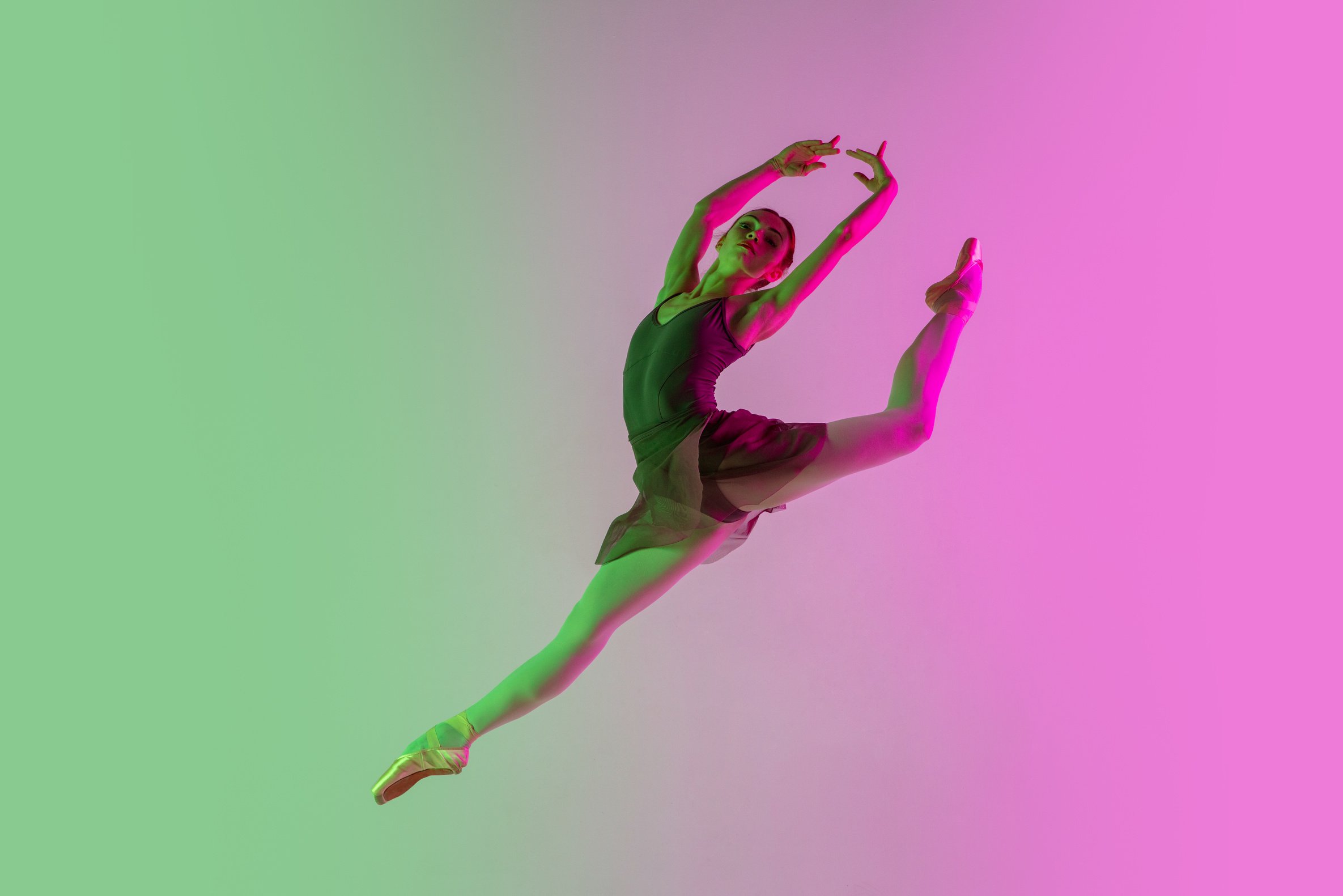 Young and Graceful Ballet Dancer Isolated on Gradient Pink-Green Studio Background in Neon Light. Art in Motion